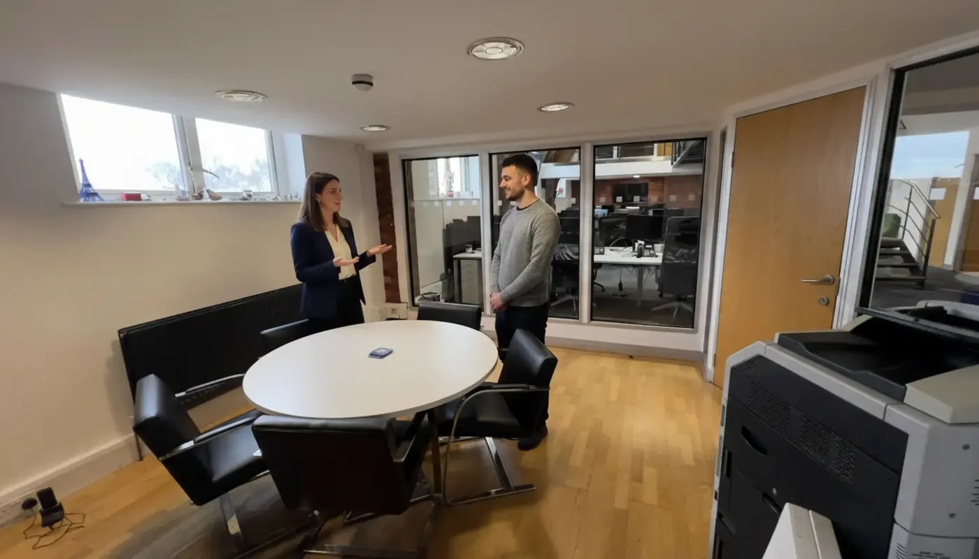 Jessica and Adam discussing UK local SEO timelines inside a modern UK office.