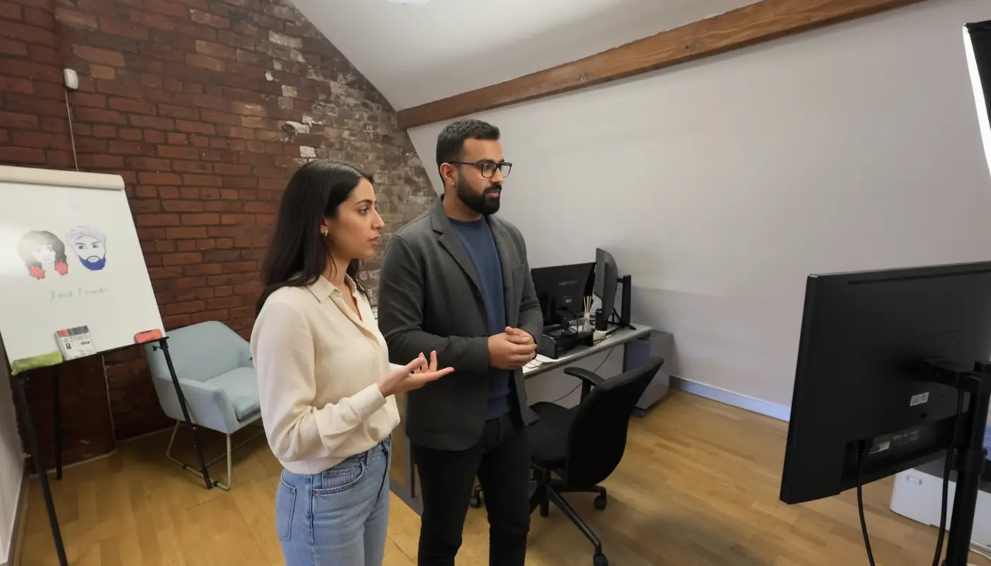 Omer and Sara collaborating in a UK creator studio discussing TikTok video planning.