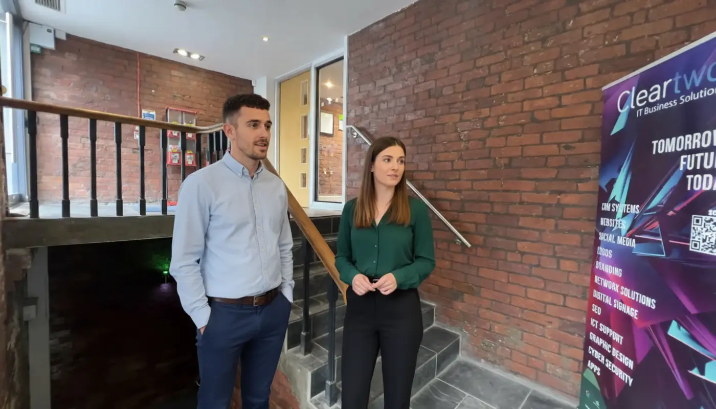 Adam and Jessica discussing UK eCommerce setup inside an office environment.