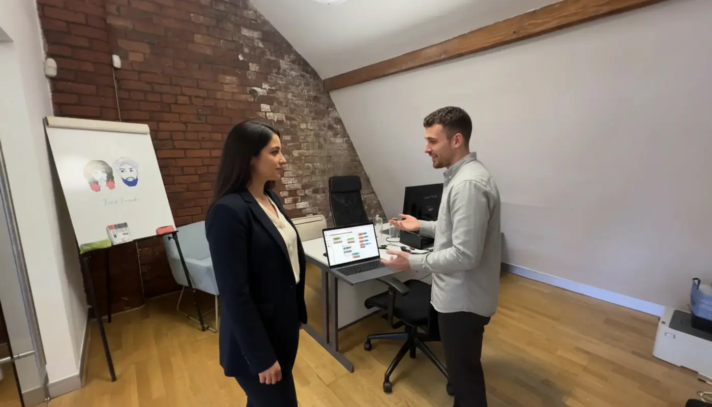 Sara and Adam discussing workflow automation inside a UK office setting.