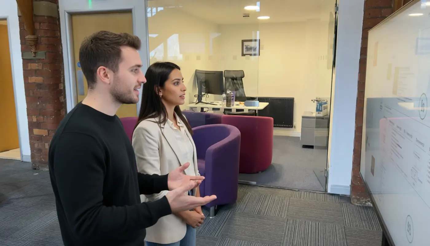 Adam and Sara in a UK ecommerce workspace discussing automation strategy.