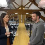 Jessica and Adam collaborating in a UK office discussing AI voice agent development.