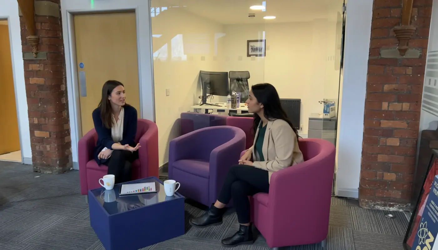 Jessica and Sara collaborating inside a UK creator studio, discussing social media content strategy.
