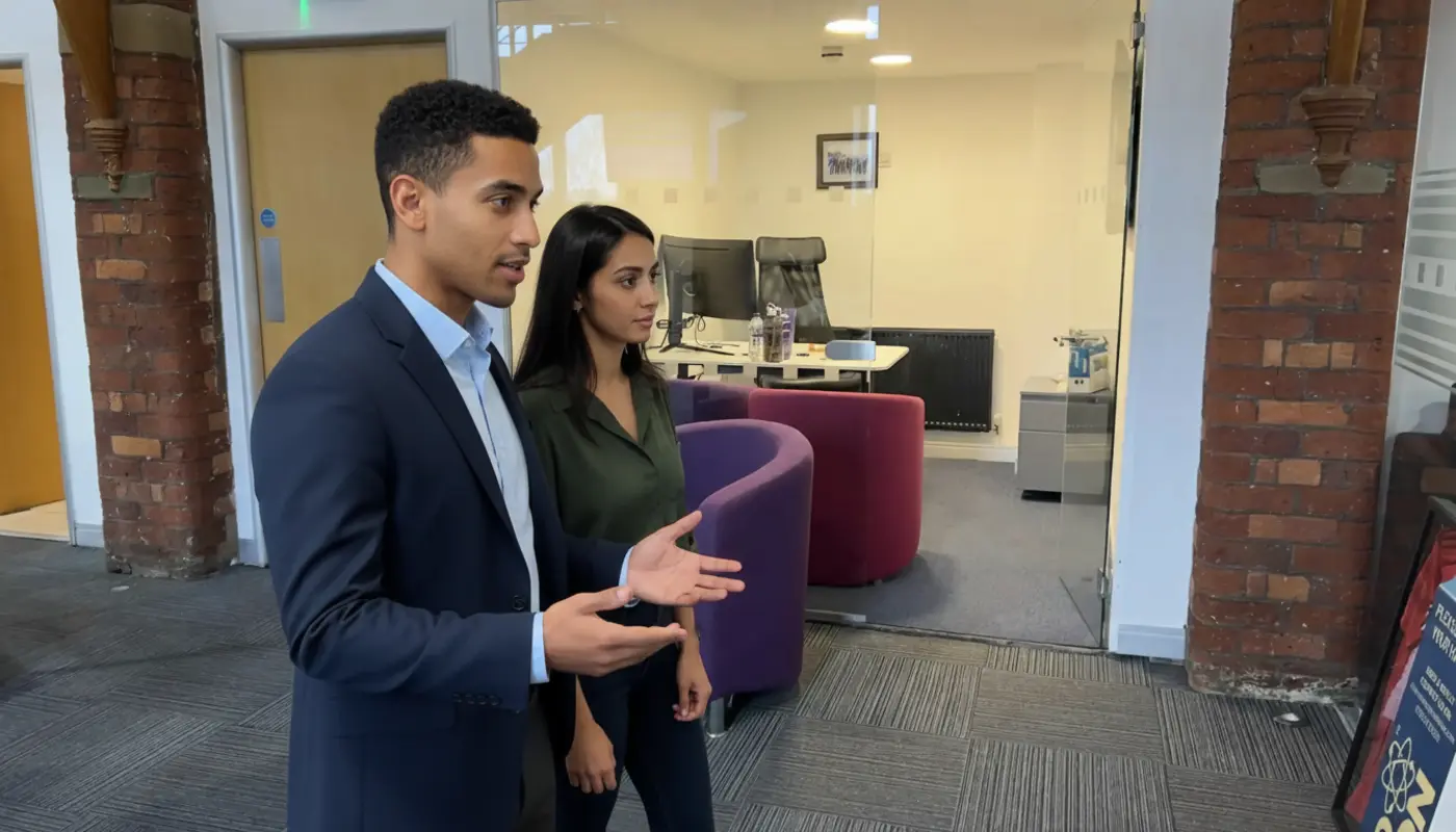 Zak and Sara discussing website planning inside a UK office.