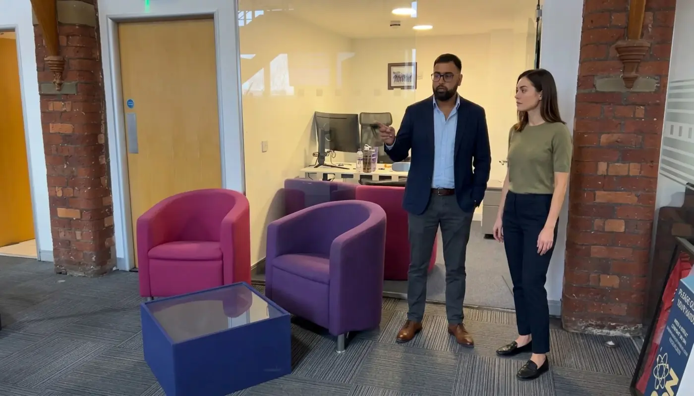 Two professionals discuss planning a business website while standing in a Cleartwo office.