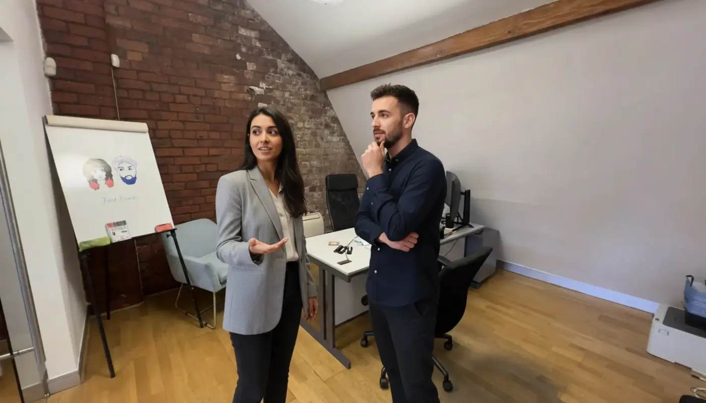 Sara and Adam discussing Business Central planning inside a UK office environment.