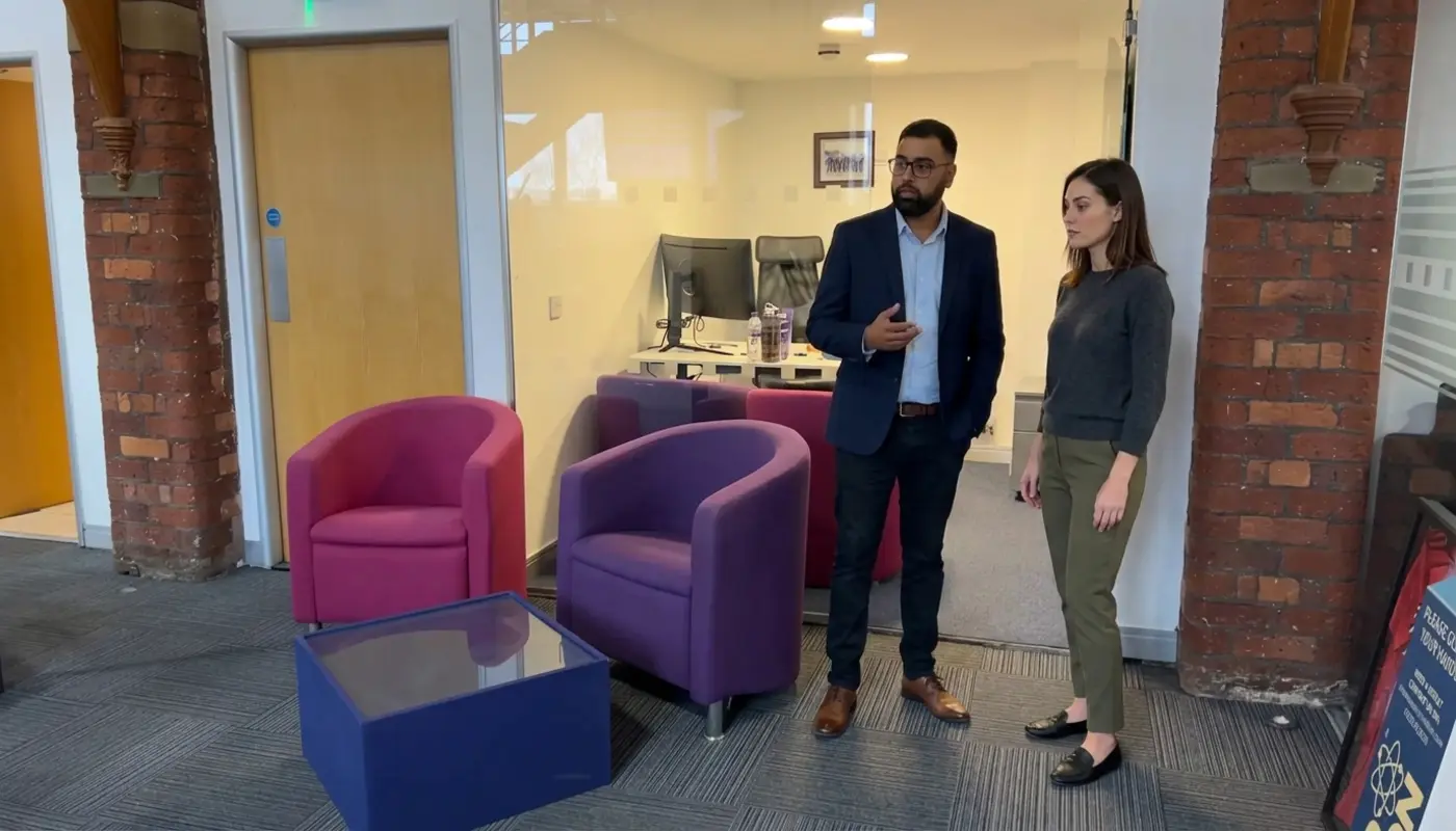 Two professionals discuss website page structure in a modern office during an SEO planning conversation.