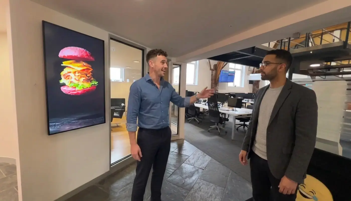 Two professionals discuss continuity planning while walking through a modern office with a focus on operational resilience.