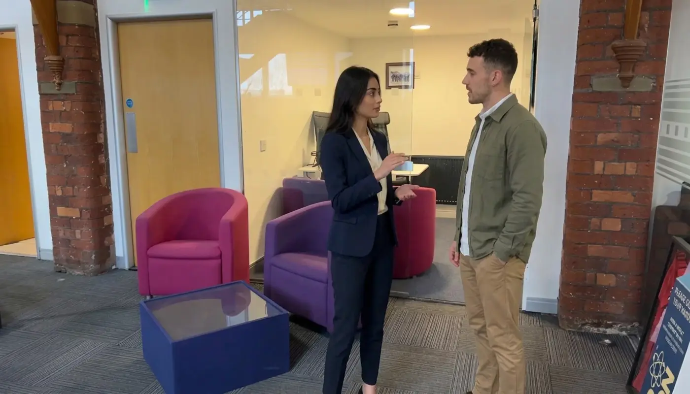 Two colleagues discuss a TikTok Shop launch plan while standing in a modern office workspace.