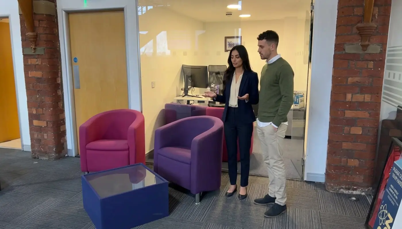 Two colleagues discuss Microsoft 365 installation planning in an office workspace.