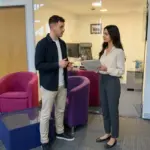 Two colleagues discuss seller setup documents in a UK office during TikTok Shop launch planning.