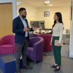 Two professionals discuss Shopify SEO agency selection in a UK office consultation.