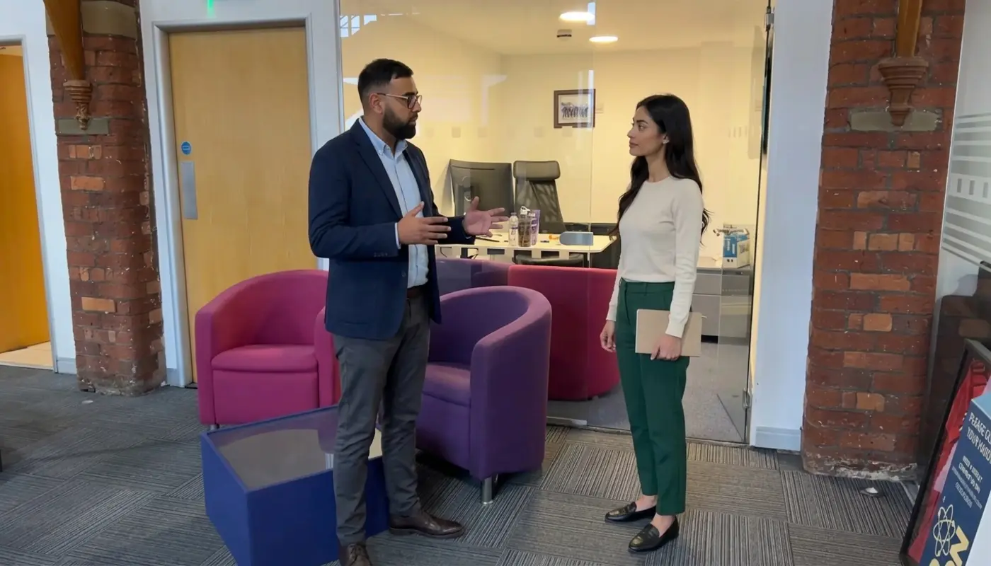 Two professionals discuss Shopify SEO agency selection in a UK office consultation.